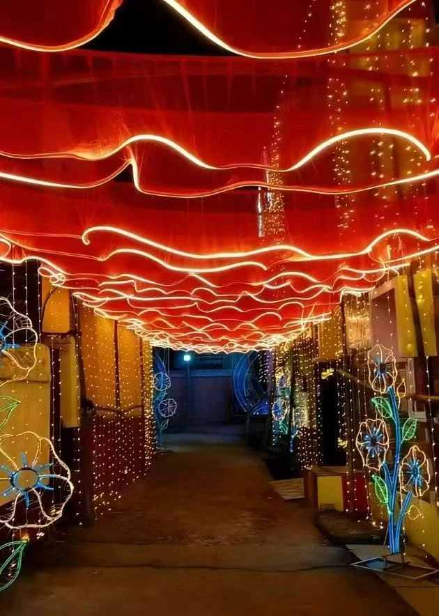 Red fabric waves with LED-lit edges in an event setting